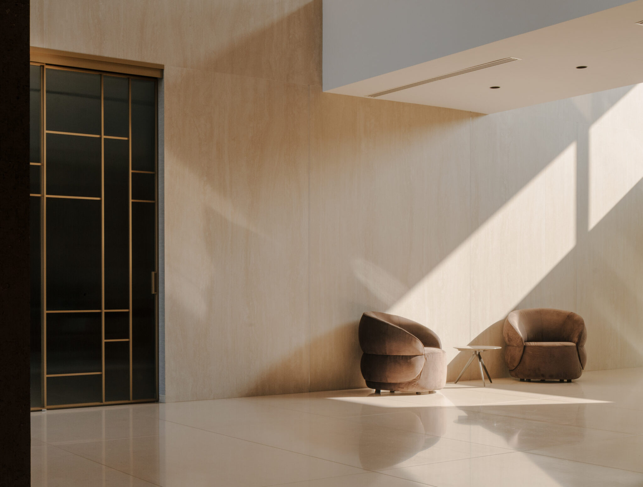 Elegant modern interior with comfortable armchairs and unique lighting at Studio 9.