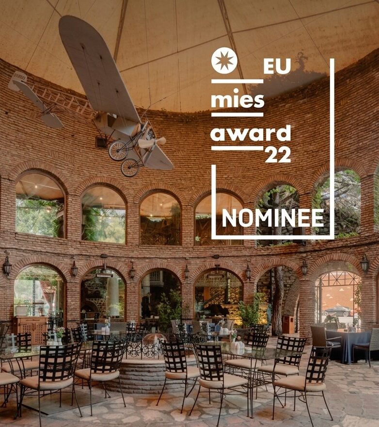 Interior of Studio 9 with brick walls and large arched windows, Mies Award 2022 nominee.