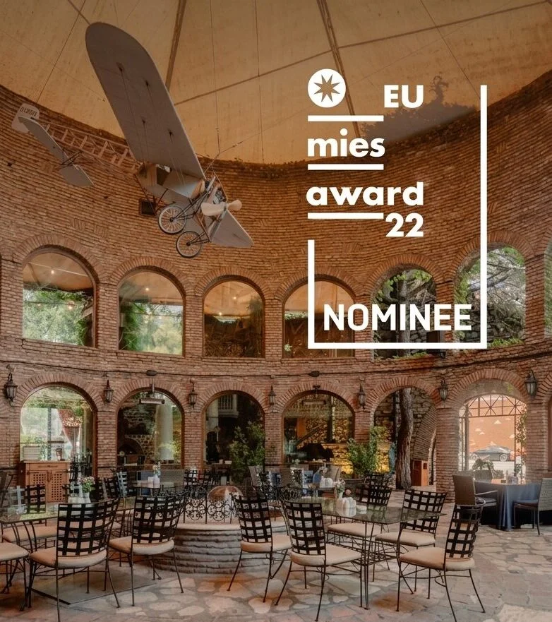 Interior of Studio 9 with brick walls and large arched windows, Mies Award 2022 nominee.