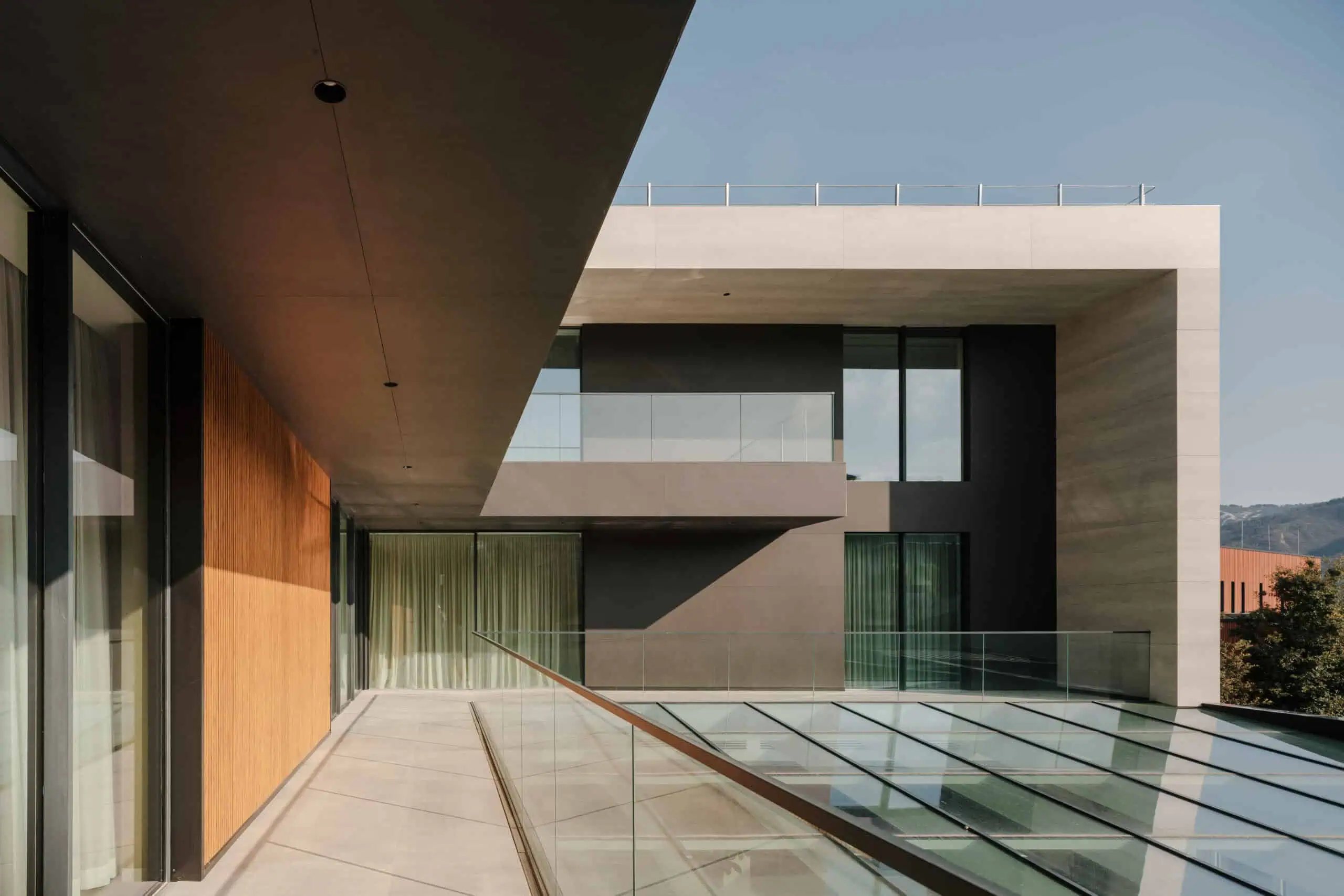 Contemporary modern building with sleek glass balconies and minimalist design.