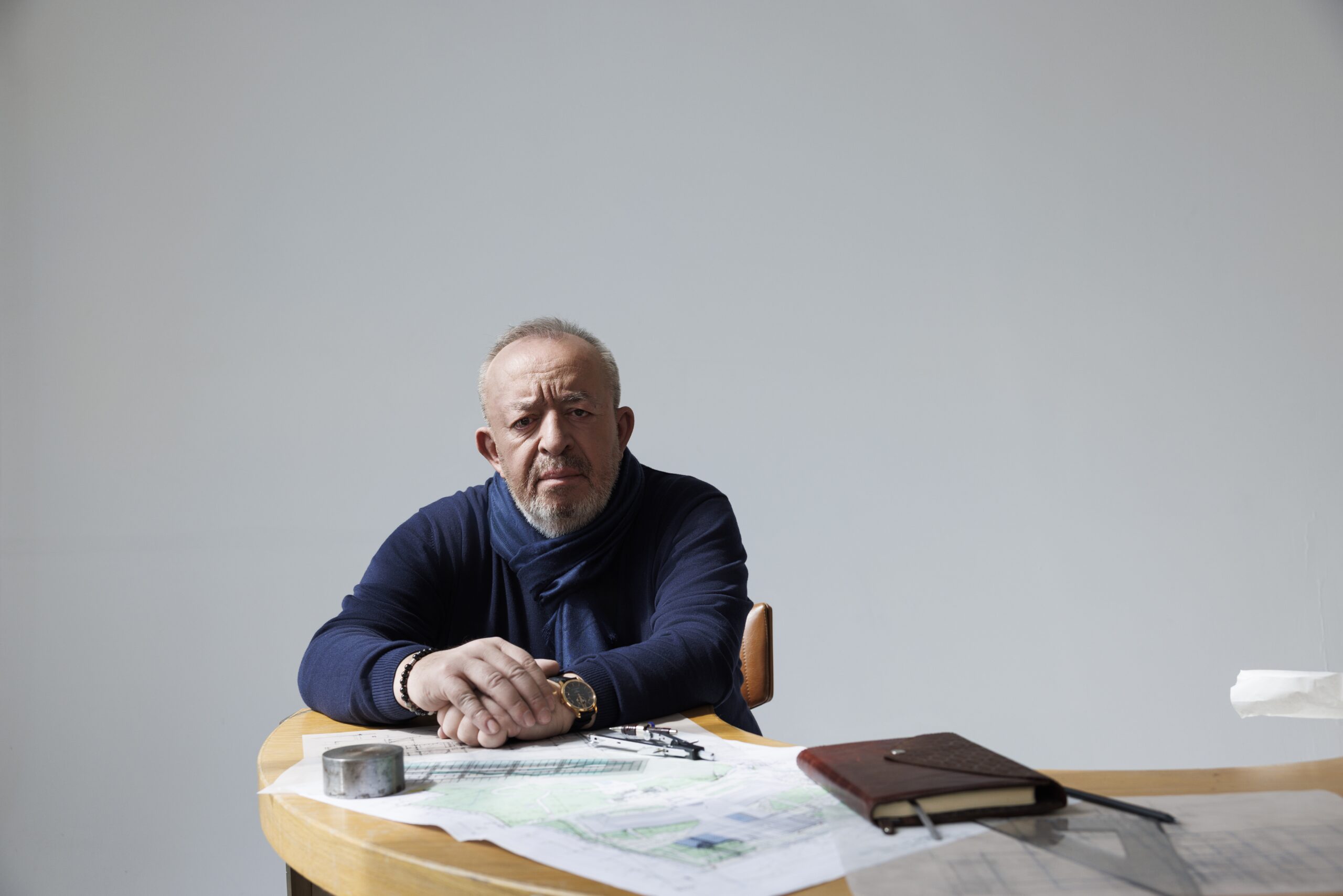 Experienced architect or designer reviewing plans at studio9.ge office, demonstrating creativity and professionalism.