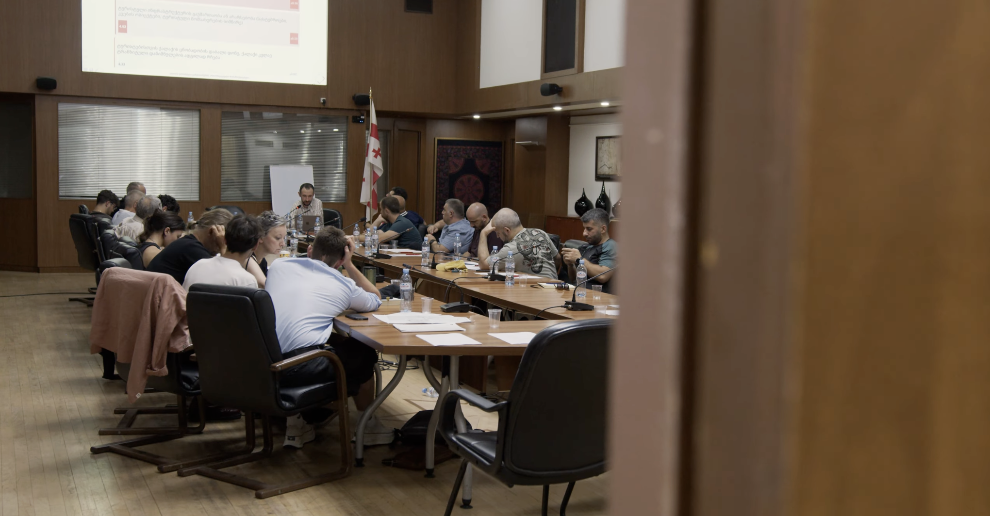 Conference room with diverse professionals attending a meeting at Studio 9.