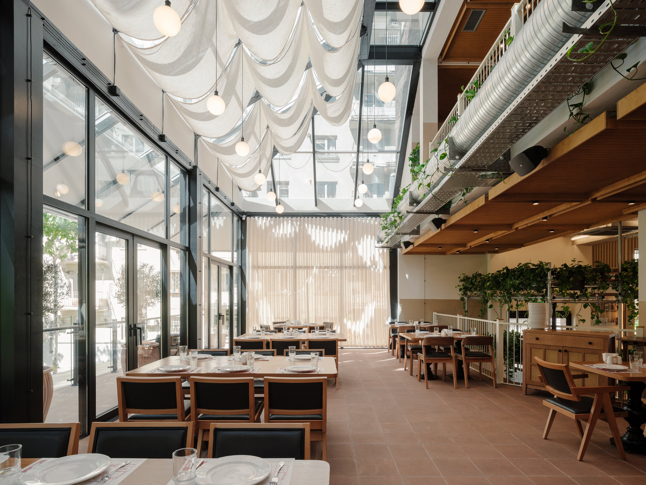 Spacious restaurant with large glass windows and elegant decor.